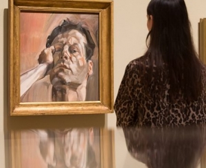 Viewer observing Lucian Freud work at Royal Academy